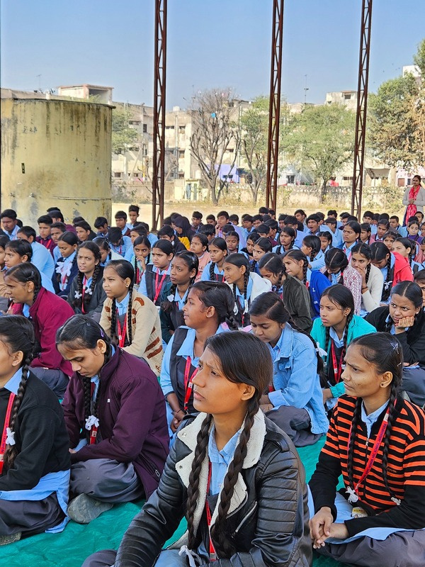 Students seated in the open ground