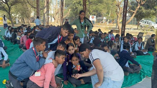 Students gathered around a device